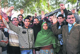 Chamel Singhs family members stage a protest outside the Divisional Commissioners office in Jammu on Monday.