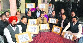 Congress councillors hold a protest at the Zone A office of the MC in Ludhiana on Monday.