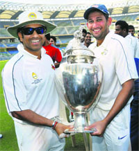Sachin Tendulkar and Ajit Agarkar with the Ranji Trophy in Mumbai on Monday