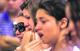 Relatives of victims of the fire at Boate Kiss nightclub attend a prayer meeting in Santa Maria.