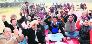 Members of the Punjab Health Department Subordinate Offices Clerical Association protest at Government Medical College in Amritsar on Tuesday. 