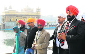 IHRO General Secretary Harinder Singh (right) pays obeisance at the Golden Temple on Tuesday. 