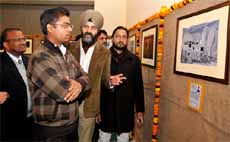 ADC (D) Mohammad Tayyab has a close look at a photograph on display at the exhibition that he inaugurated at Government Rajindra College on Tuesday. The exhibition will be open for the general public till February 2