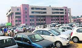 Vehicles at the parking lot outside the new District Courts Complex at Sector 43, Chandigarh, on Tuesday