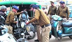 Policemen tow away wrongly parked two-wheelers at Chandracharya Chowk, Ranipur market, in Haridwar on Tuesday.