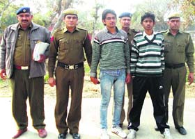 Policemen escort Vijender and Mohit, accused in the gang rape of a minor, to a court in Sonepat on Tuesday