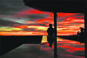 A tourist looks on as the sun goes down in Shimla. 