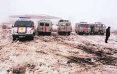 Rescue vehicles and ambulances parked near the site of a plane crash outside Almaty on Tuesday.