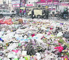 As ditch machines go out of order, garbage piles up along Plaza Chowk and the Old GT Road, a few metres from the MC office, in Jalandhar on Wednesday. 