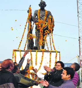 Locals pay floral tributes to Mahatma Gandhi during a function on his martyrdom day in Jammu on Wednesday