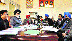Mayor Harcharan Singh Gohalwaria (second from left), MC Commissioner Rakesh Kumar Verma (extreme left) and senior MC officials take part in a meeting of the Finance and Contract Committee at the Mayor's camp office in Ludhiana on Wednesday
