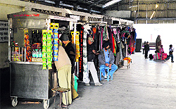 Owners of the stalls, which have been shifted from platform No. 1 to Musafirkhana, wait for customers at the railway station in Ludhiana on Wednesday