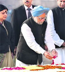Prime Minister Manmohan Singh pays homage to Mahatma Gandhi on Martyrs Day at Rajghat in New Delhi on Wednesday. 