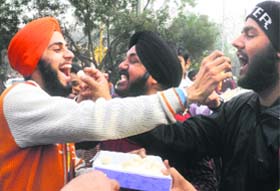 SWEET SUCCESS: SAD workers in Delhi celebrate the party win in gurdwara elections