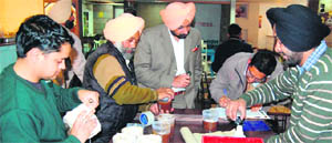 District Health Officer Dr Shivkaran Singh Kahlon along with the raiding team collects samples at a food joint in Amritsar on Thursday. 