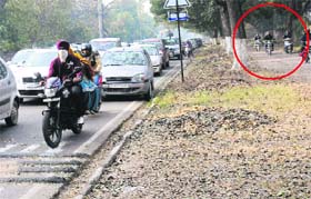 Two-wheeler drivers use the cycle path to avoid traffic jam caused by rumble strips near the roundabout.