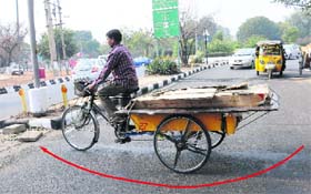 A rehri puller takes the new cycle traffic way at Sectors 30,20,19 and 27 roundabout.