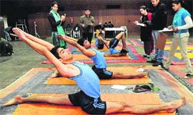 Participants perform in an inter-college yoga competition at Gymnasium Hall of Panjab University, Chandigarh, on Thursday.