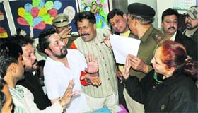 People argue with the headmistress of Government School, Sector 30, in Chandigarh on Thursday.