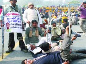 The physically challenged hold a protest against External Affairs Minister Salman Khurshid, accused of financial wrongdoing in the purchase of equipment for them, near Shastri Bhawan in New Delhi on Thursday. 