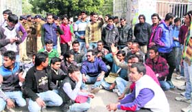 NSUI members hold a protest outside the main gate of the college.