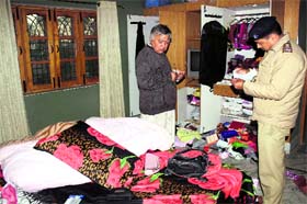 A police official examines the ransacked house in the Raipur area, Dehradun, on Thursday.