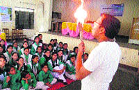 A trainer shows a miracle of science to school students in Rishikesh on Thursday.