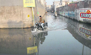Motorists pass through the water-logged Ikheri Pull in Jalandhar. 