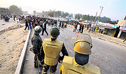 Policemen try to control protesters in Jammu on Thursday