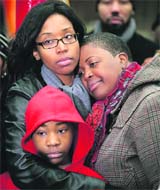 Cleopatra Cowley-Pendleton (R) is comforted by her sister and nephew at a park where her daughter Hadiya was killed in Chicago on Wednesday.