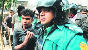 Police detains a suspected activist of Bangladesh Jamaat-e-Islami during a strike in Dhaka on Thursday.