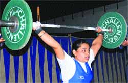 A girl lifts weight during the Panjab University Inter-College Weightlifting (women) Championship in Chandigarh, on Friday. 