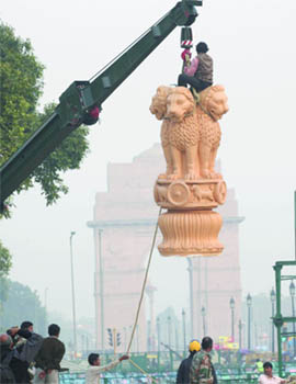 Army jawans and workers remove the national emblem Ashok Stambh with a crane at Rajpath. It was placed in front of saluting base for the Republic Day parade, in New Delhi on Friday. 