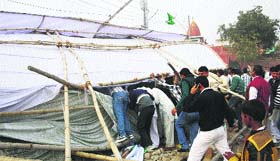 A tent that was raised for an INLD programme collapses in Rohtak on Friday.