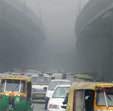 Vehicles stuck in a jam on a foggy day in New Delhi on Friday. 