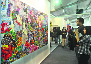 Visitors check out art work Mirage no-7 by Ye Hongxing during the 5th edition of the India Art Fair-2013 at NSIC Ground in New Delhi on Friday. 
