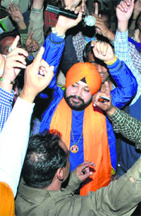 Punjabi pop singer Daler Mehndi perform with truck drivers during the shooting of his new video album in Patiala on Friday. 