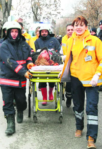 Rescuers take a victim of a blast outside the US Embassy in Ankara to an ambulance on Friday. 