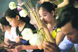 People burn incense sticks and lay flowers for late former King Norodom Sihanouk in Phnom Penh on Friday. Sihanouk, who abdicated in 2004, died of a heart attack in Beijing on October 15, 2012, and will be cremated on February 4