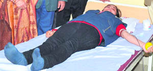 A student of Global Institutes donates blood during a camp in Amritsar on Saturday. 