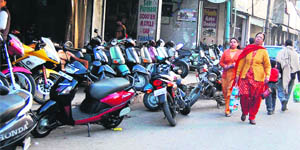 Encroachments by shopkeepers have eaten up footpaths. 
