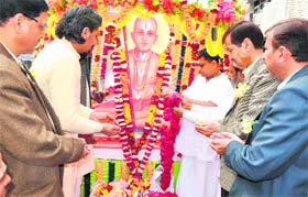 Matter of faith: Saints and administrative officials offer flowers at the royal processon taken out as part of Jagad Guru Ramanandacharya Jayanti in Haridwar on Saturday