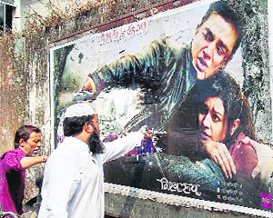 Protesters tearing a poster of Kamal Haasans movie Vishwaroopam in Mumbai.