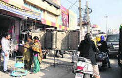  Shopkeepers encroach upon the road by displaying their goods at Nakodar Chowk.