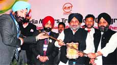 Members of the All India Motor Transport Congress honour Deputy CM Sukhbir Badal during a convention on road safety in Amritsar on Saturday.
