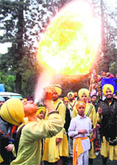 A youth performs a stunt during a religious procession on the birth anniversary of Shaheed Baba Deep Singh in Amritsar on Sunday.