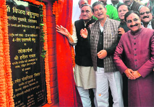 Chief Minister Vijay Bahuguna, Union Water Resources Minister Harish Rawat and former Chief Minister Ramesh Pokhriyal Nishank at the inauguration of an overbridge at Lachchiwala near Dehradun on Sunday