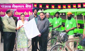 Patiala ADC (D) Anindita Mitra flags off green cabs in Patiala.