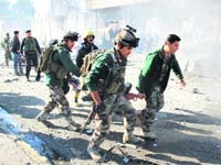 Soldiers carry an injured person to a safer place in Kirkuk on Sunday
