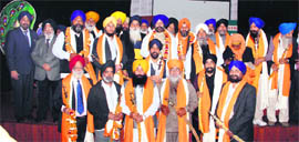 Office-bearers of the Chief Khalsa Diwan honour members of the Delhi Sikh Gurdwara Management Committee in Amritsar on Monday.